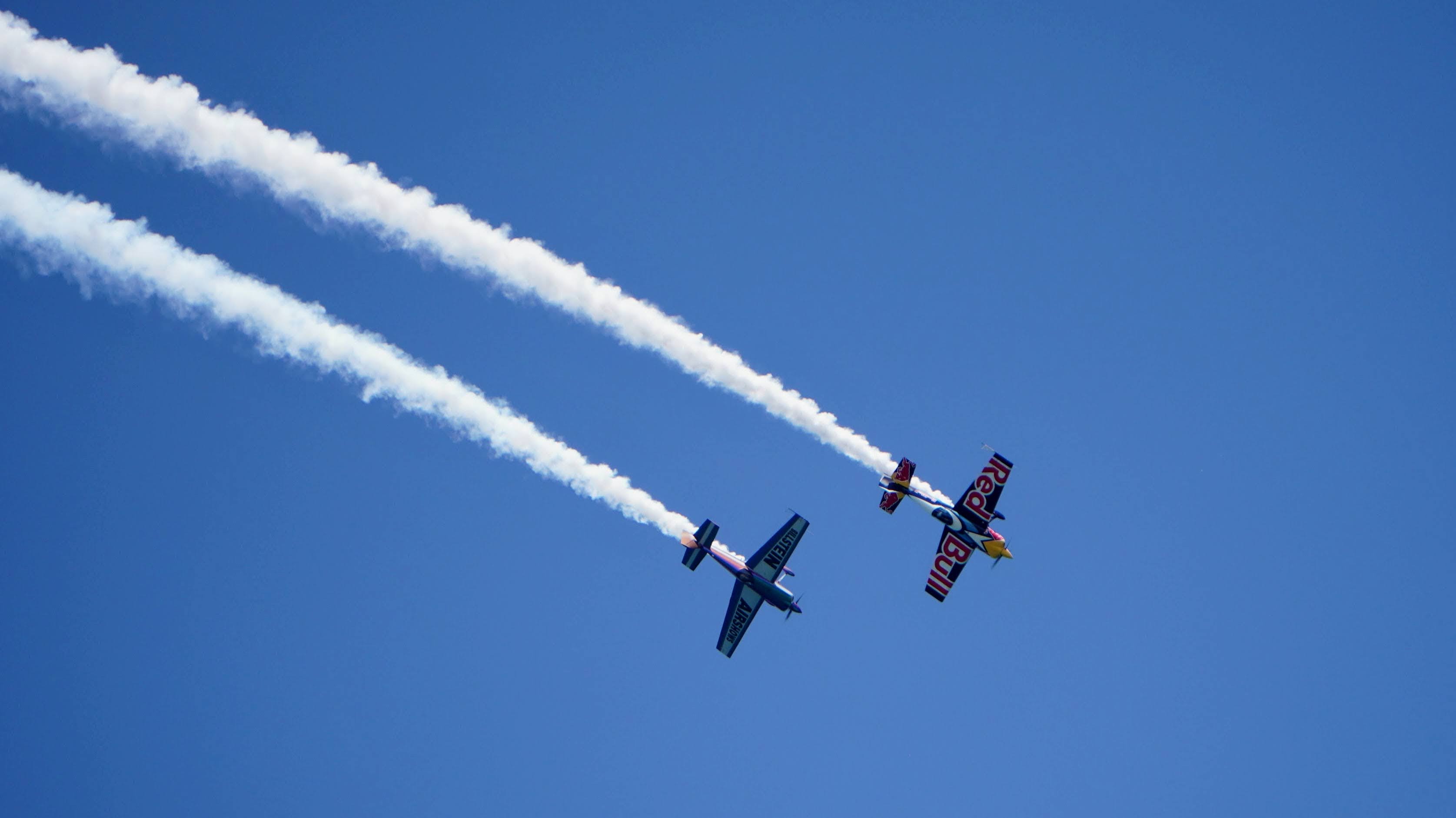 A Red Bull airplane and one from Bill Stein Airshows race through the Hoosier skies over Lake Michigan and Miller Beach