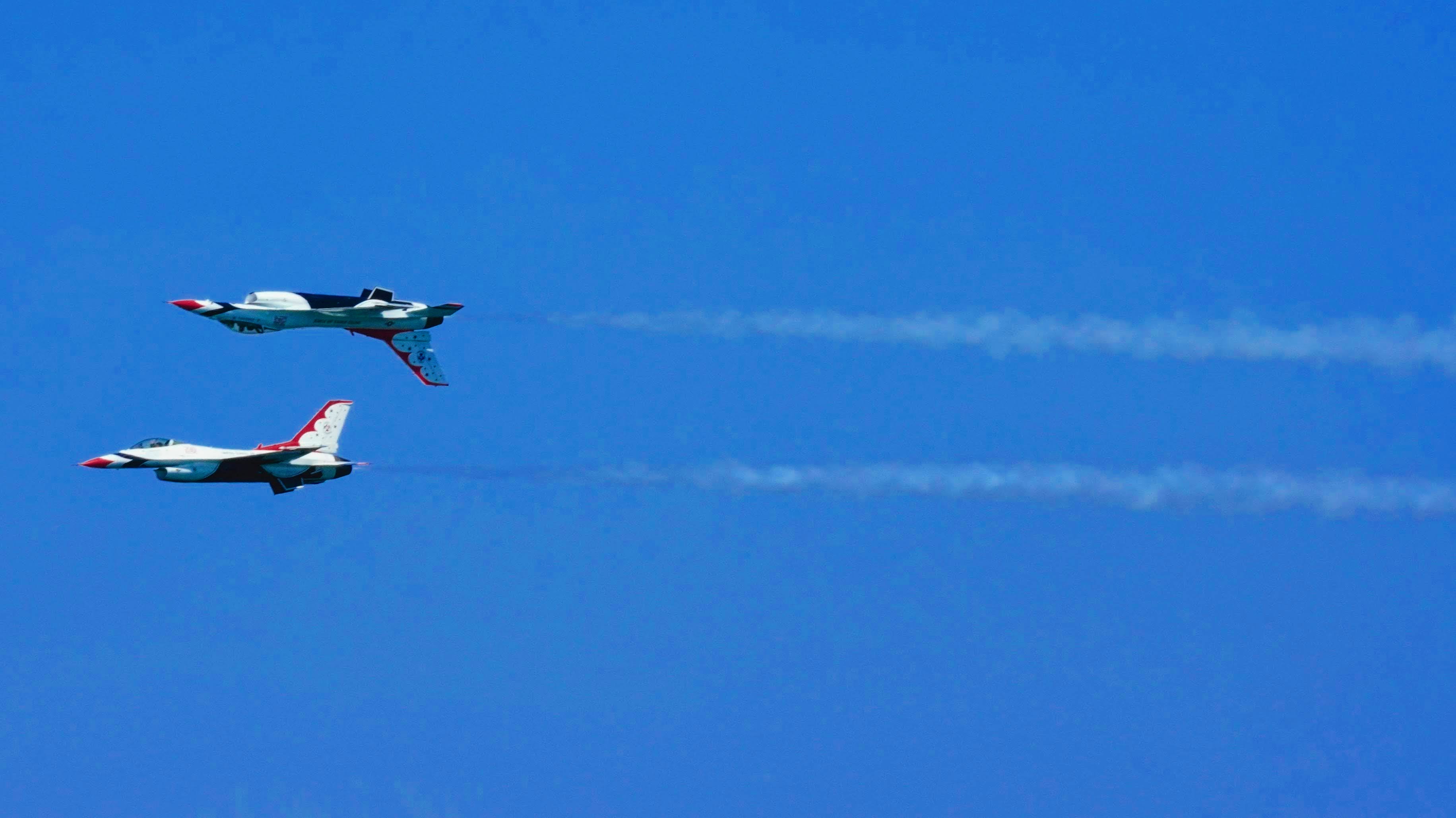 The US Air Force Thunderbirds. One plane is rightside up. The other is above upside down.